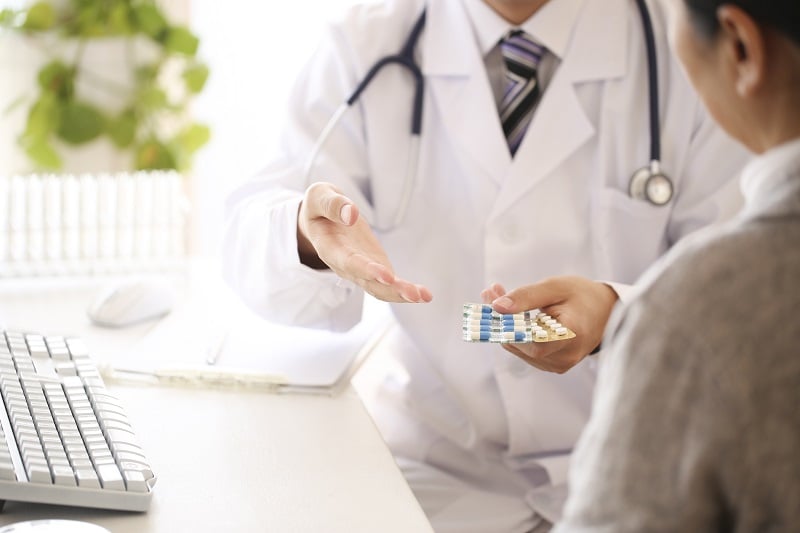 Doctor giving personalized medicinal drugs to a patient
