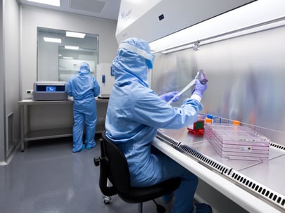 Scientists in a clinical cell culture production lab
