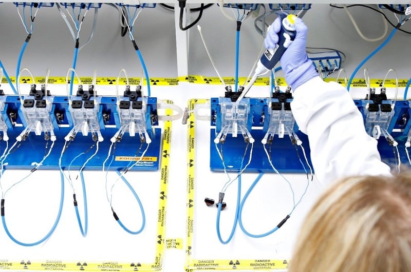 Scientist inserting a pipette into an ussing chamber