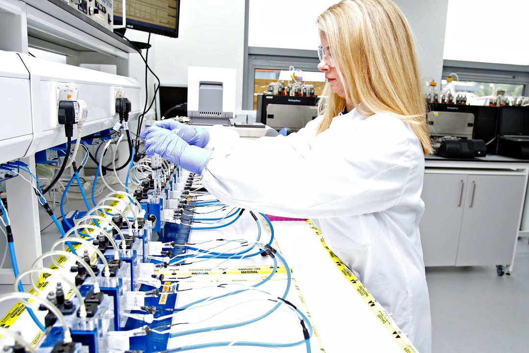 Image of scientist holding a human skin sample with holes punched out of it 