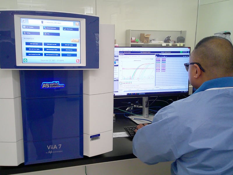 Scientist using RT-PCR equipment