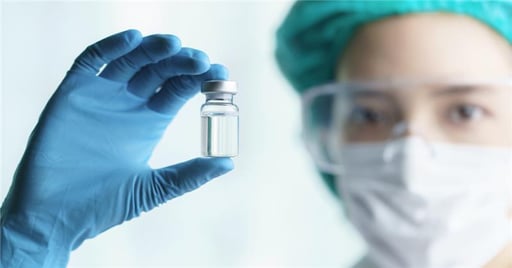 Stem cell scientist holding a glass vial
